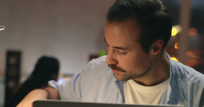 Young caucasian man doing scientific research using laptop