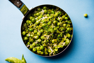 Green peas dry recipe or matar ki sookhi sabji, served in a serving pan or terracotta bowl. Selective focus
