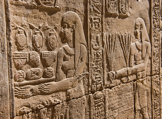 Hieroglyphic carvings on an ancient egyptian temple wall