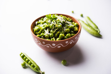 Green peas dry recipe or matar ki sookhi sabji, served in a serving pan or terracotta bowl. Selective focus