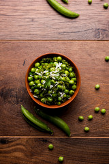 Green peas dry recipe or matar ki sookhi sabji, served in a serving pan or terracotta bowl. Selective focus