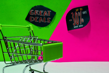 green shopping cart. attached Great Deals and Up To 30% Off Shop Now text on green and pink background. E-commerce and business marketing concept