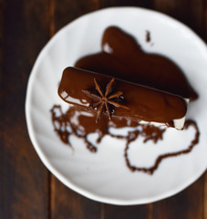 pastille in chocolate icing on a white plate
