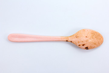 dirty plastic spoon top view isolated on white background