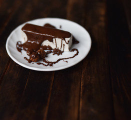 pastille in chocolate icing on a white plate
