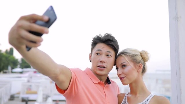Young couple make selfie photos of their kiss