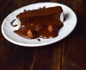 pastille in chocolate icing on a white plate
