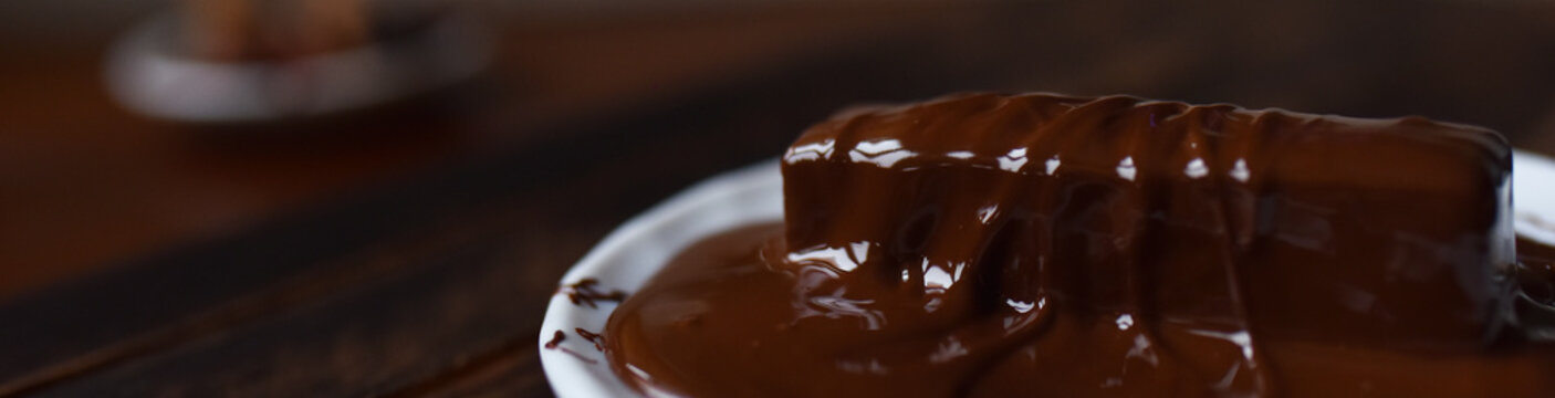 pastille in chocolate icing on a white plate
