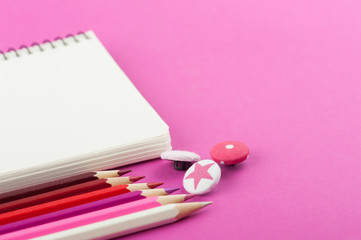 Pink working desk with empty notebook