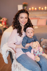 family photo session of mom and daughter on the bed with candles and flowers