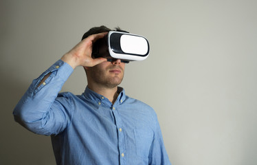 Handsome man in virtual reality goggles. Space for your text.