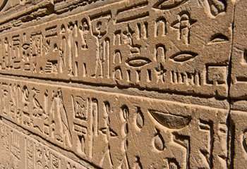 Hieroglyphic carvings on an ancient egyptian temple wall