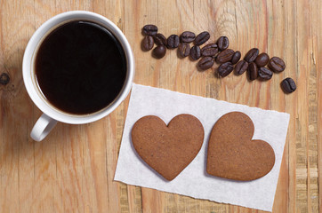 Two ginger cookies in shape of heart and coffee