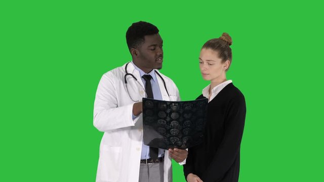 Young woman visiting radiologist for x-ray exam of her brain on a Green Screen, Chroma Key.
