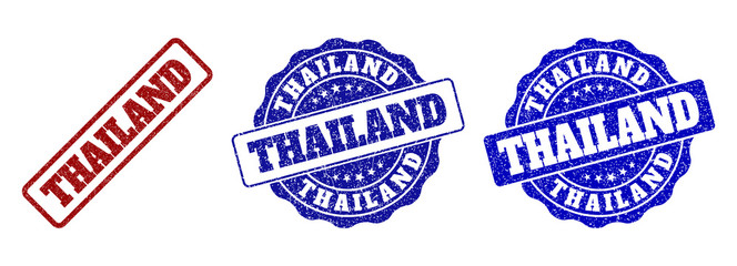 Obraz premium THAILAND scratched stamp seals in red and blue colors. Vector THAILAND labels with grainy effect. Graphic elements are rounded rectangles, rosettes, circles and text labels.
