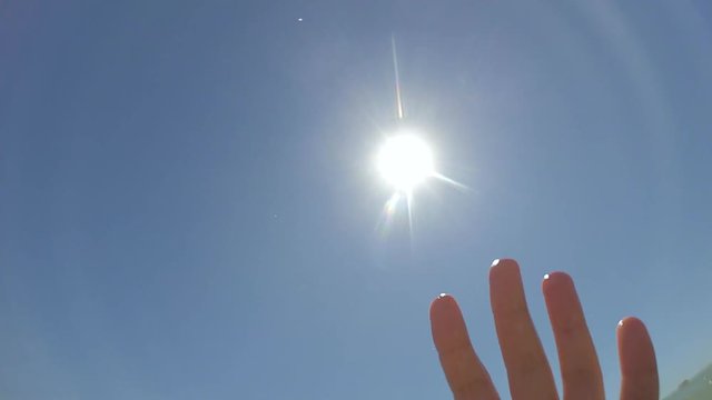 Slow motion POV. The hand of the man who sinks drowning, the hand rises and falls over the sea level close-up, clear cloudless blue sky, sun and transparent clear water. Wide angle