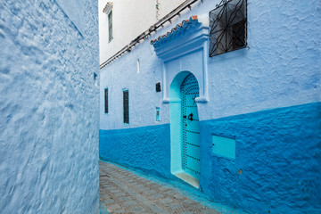 street with emerald door in blue city Chefchaouen in Morocco