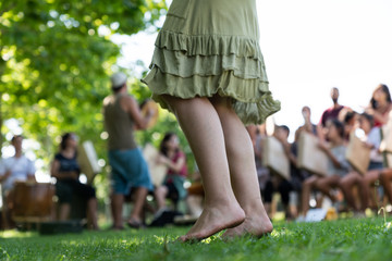Crop girl dancing on grass