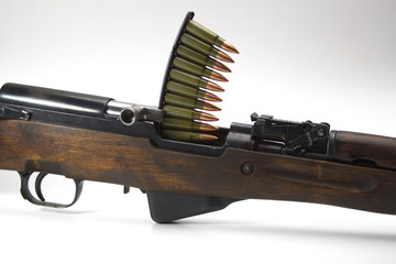 Simonov self-loading carbine with a clip of cartridges on a white background close-up