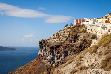 Fototapeta na wymiar A panoramic view of the white city with blue roofs against the background of the Aegean Sea - the most romantic island in the world