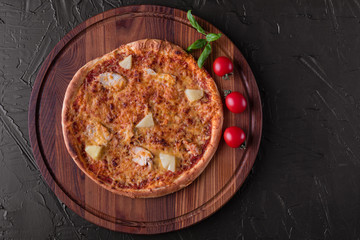 Pizza, food, vegetable, margarita.  Vegetables, mushrooms and tomatoes pizza on a black wooden background. It can be used as a background