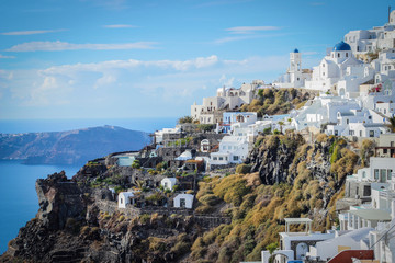 A panoramic view of the white city with blue roofs against the background of the Aegean Sea - the most romantic island in the world