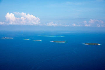 Fototapeta na wymiar Aerial of the beautiful Maldives, looking down at some stunning islands and atolls