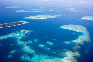 Fototapeta na wymiar Aerial of the beautiful Maldives, looking down at some stunning islands and atolls