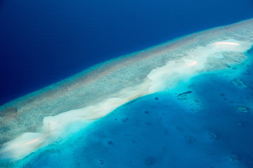 Aerial of the beautiful Maldives, looking down at some stunning islands and atolls
