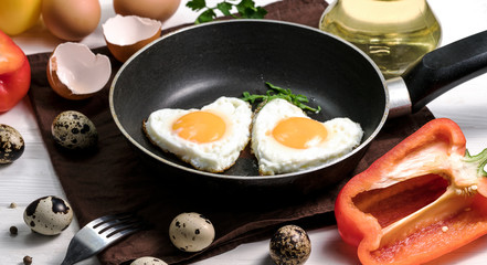 Fried eggs on a skillet on a wooden background