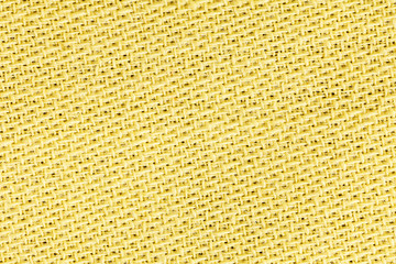 Yellow linen fabric of cloth texture background. Detail of textile material close-up.