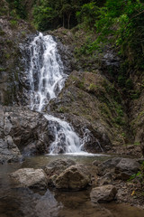 Fototapeta na wymiar Beautiful waterfall in a green tropical forest