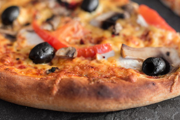 Pizza, food, vegetable, mushrooms.  Vegetables, mushrooms and tomatoes pizza on a black wooden background. It can be used as a background