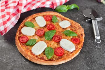 Pizza, food, vegetable, margarita.  Vegetables, mushrooms and tomatoes pizza on a black wooden background. It can be used as a background