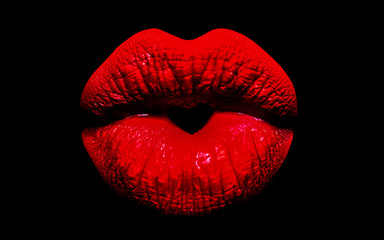 Heart icon between the lips. Red lips and a kiss with love. Lipstick and a gift for Valentine's Day. Romantic heart on a woman's mouth isolated on black background.