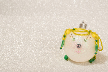 Christmas ball with a pig face on a shiny silver background