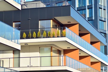Fototapeta premium Modern apartment buildings on a sunny day with a blue sky. Facade of a modern apartment building