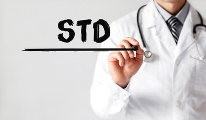 Doctor writing word STD with marker, Medical concept - obrazy, fototapety, plakaty