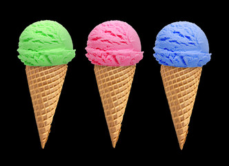 Blueberry, strawberry and mint ice cream scoops with cone isolated on black background
