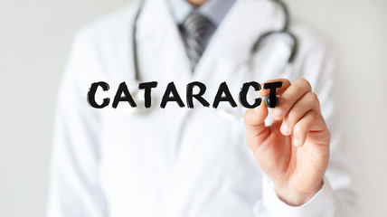 Doctor writing word CATARACT with marker, Medical concept