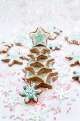 Christmas decoration. Tree cookies in the shape of stars on a white snow background. Top view.