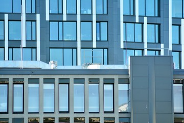 Obraz premium Facade fragment of a modern office building. Exterior of glass wall with abstract texture.