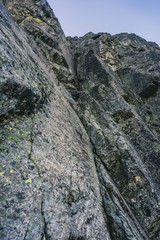 Alpine climbing adventure. A climber or an alpinist ascending big wall in High Tatras, Slovakia. Climbing on granit, Kezmarsky stit. A big wall climber in rock wall. Multipitch climbing, extreme sport