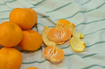 Orange tangerines on a white towel. Orange tangerines. Juicy fruit. Citrus.