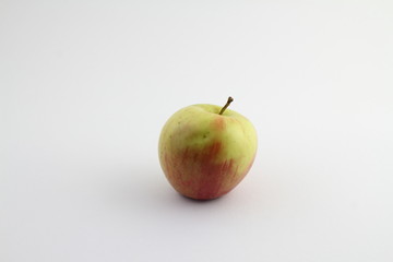 Close-up of a Green Apple on a white Background. View to a fresh Apple on a clean Background. Vegetarian Raw Food. Food and Fruit Backgrounds