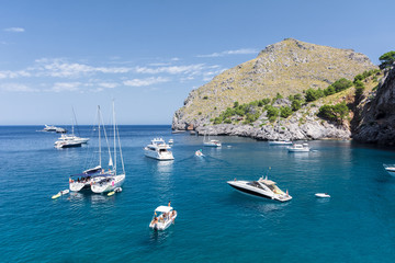 Fototapeta na wymiar Puerto de Sa Calobra, Mallorca, Spain - July 20, 2013: View of yachts, rocks and bay