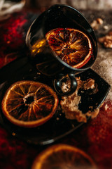 Three circles of dry orange on a plate and in a cup