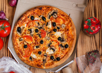 pizza, mushrooms, olives, chicken, tomato sauce, cheese, (pizza ingredients). hot pizza. Top view. copy space