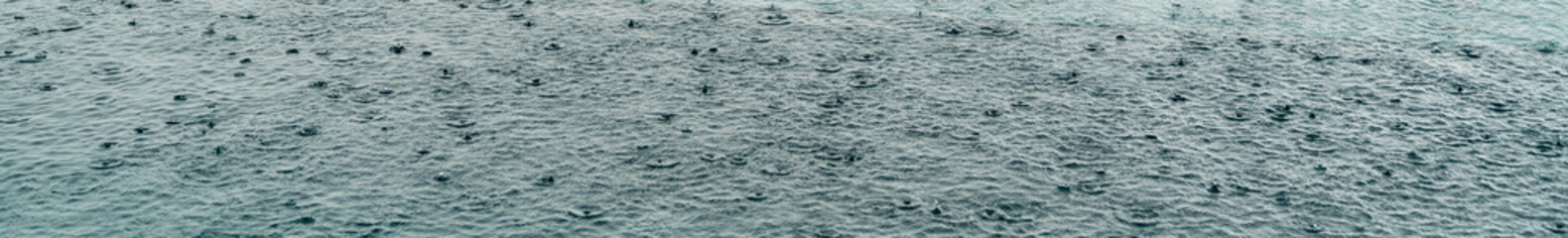 Rain splashing on pool water