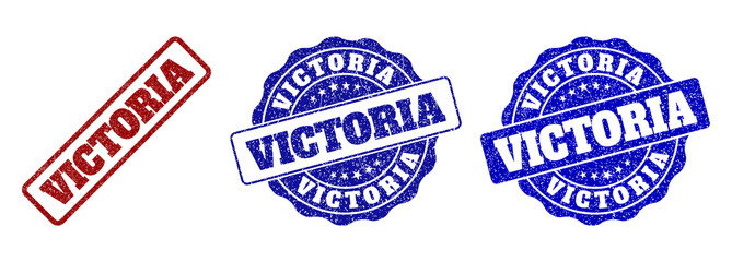 VICTORIA scratched stamp seals in red and blue colors. Vector VICTORIA labels with distress effect. Graphic elements are rounded rectangles, rosettes, circles and text labels.